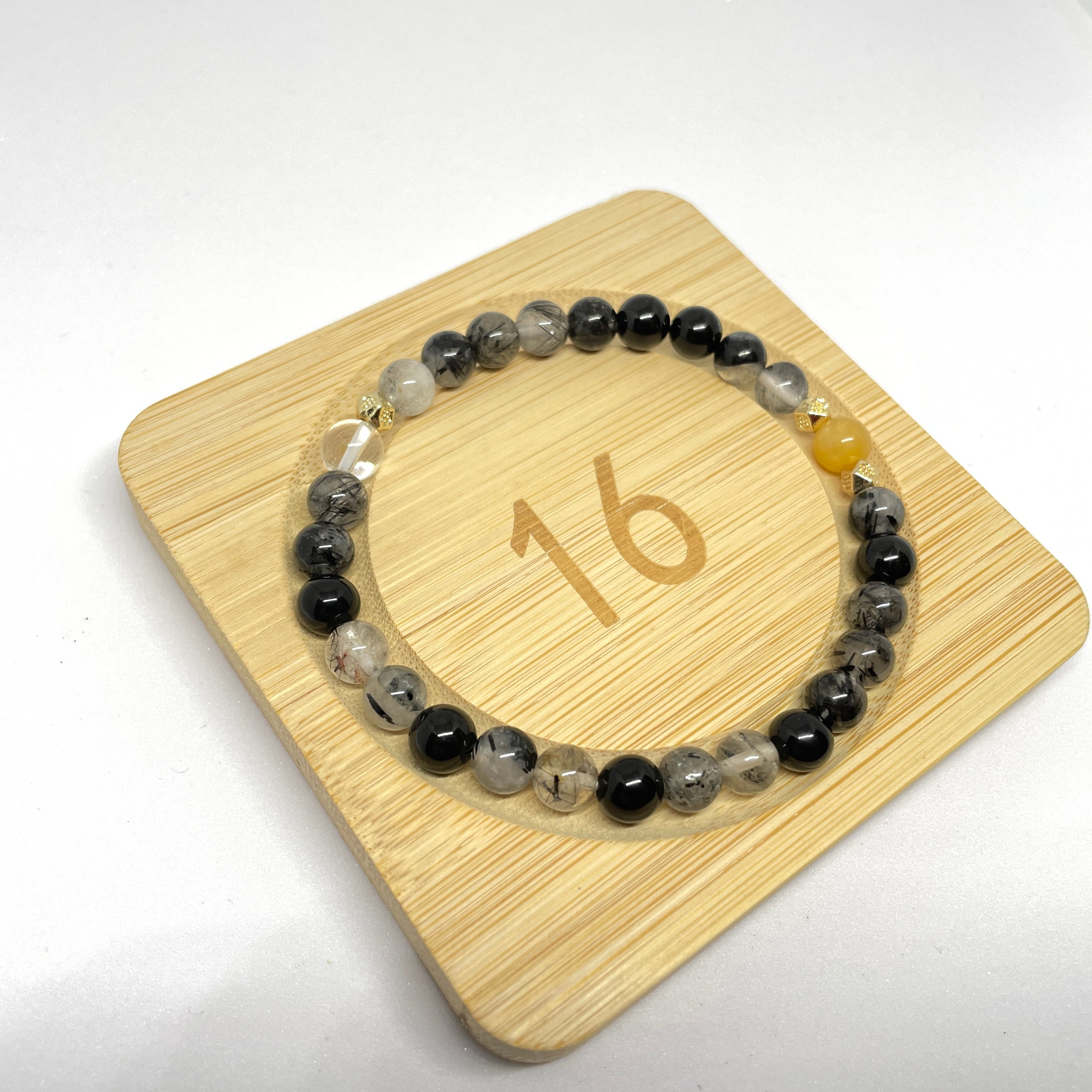 Image of a bracelet with black, yellow, and white crystals