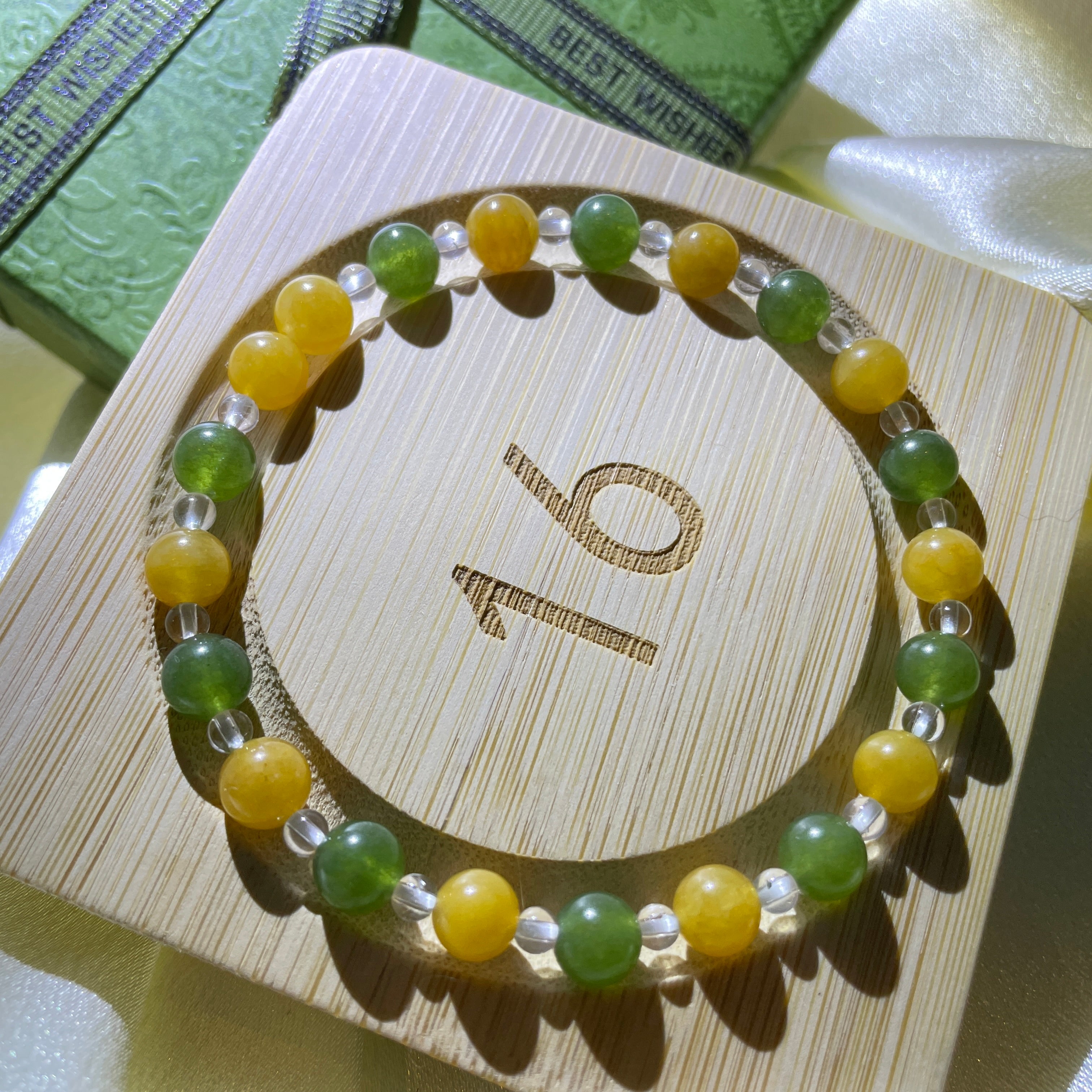 Image of a bracelet with green and white crystals