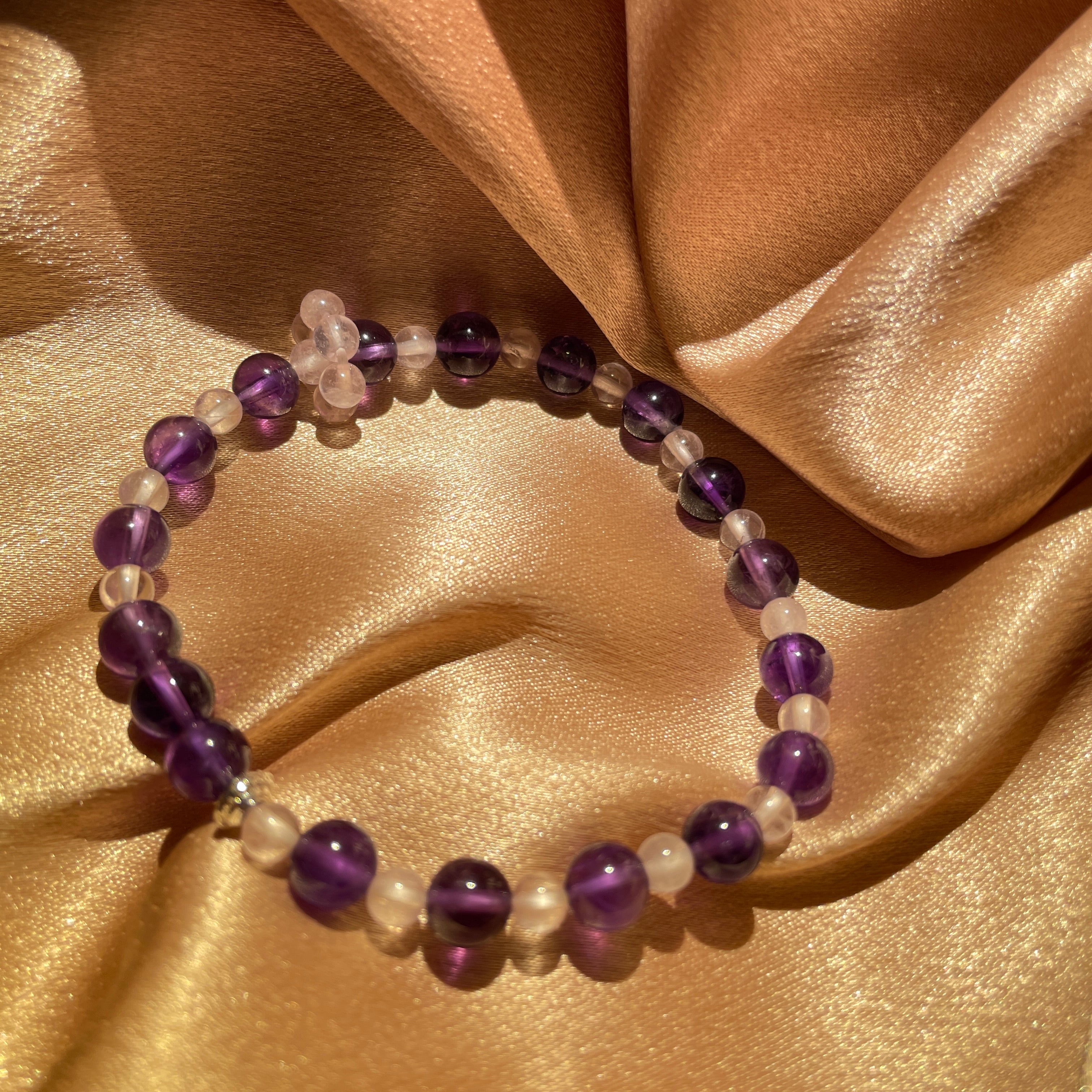 Image of a bracelet with purple and transparent crystals