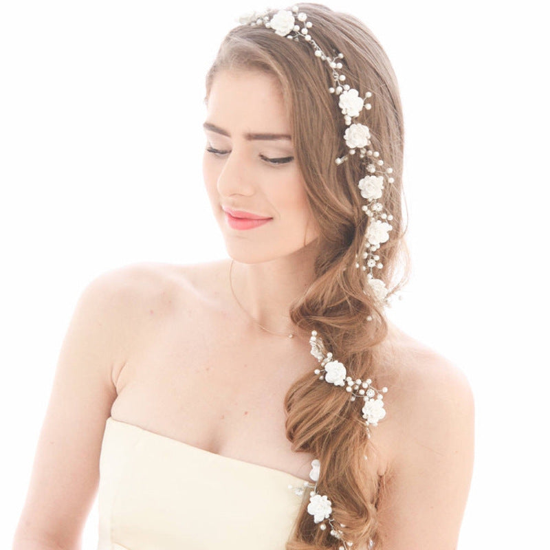 Bride's wedding photo building with makeup handmade pearl white flowers and long soft chain