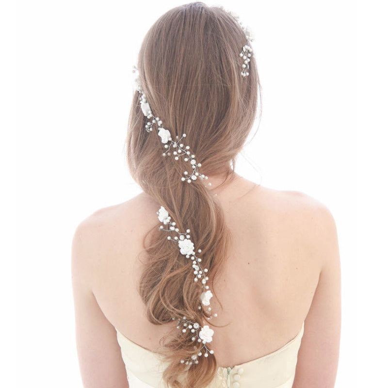 Bride's wedding photo building with makeup handmade pearl white flowers and long soft chain