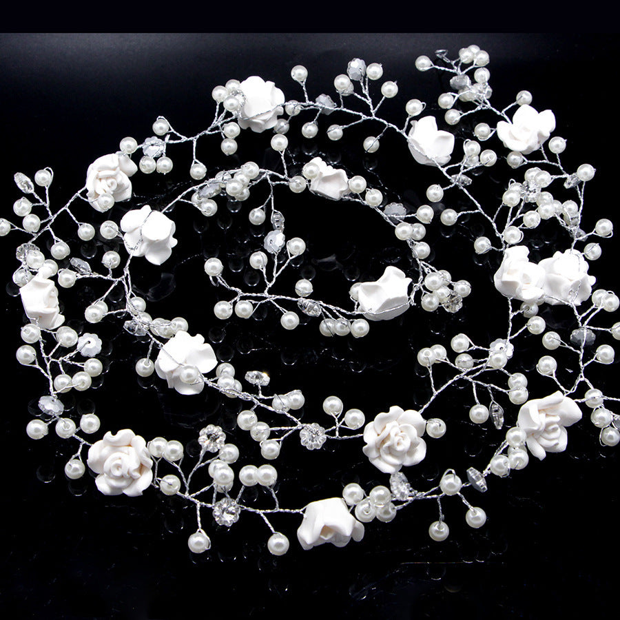 Bride's wedding photo building with makeup handmade pearl white flowers and long soft chain